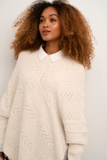 Cream holiday knit poncho with sleeves asymmetrical design oat melange Manitoba Canada