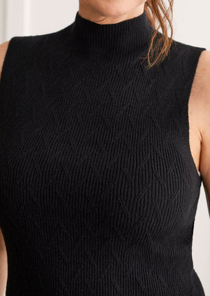 Tribal sportswear minimalist fashion black mock neck sleeveless cable knit layering essential classic sweater vest Manitoba Canada