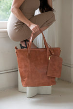 Risa Vancouver upcycled genuine leather tote with removable crossbody strap shoulder strap removable zipper pouch/wristlet responsibly sourced leather ethically made by female artisans crazy horse worn cognac brown colour Manitoba Canada