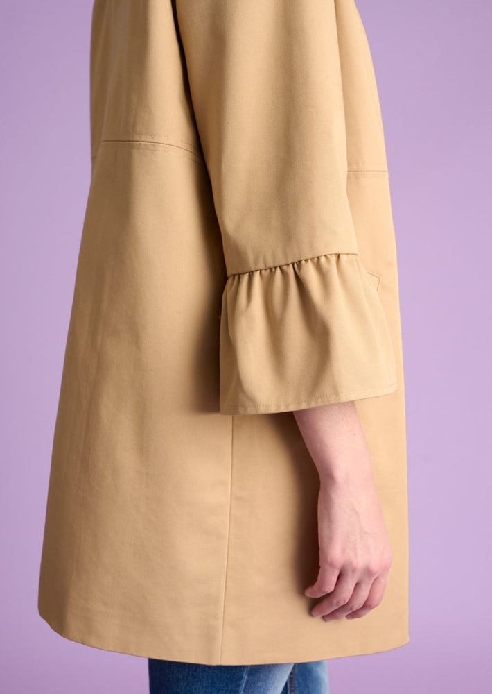 
            
                Load image into Gallery viewer, culture adrienne ruffle cuff classic short trench coat sesame beige 
            
        