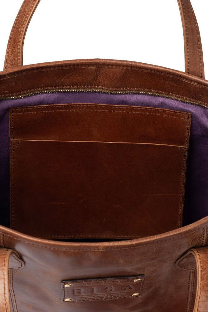 Risa Vancouver upcycled genuine leather tote with removable crossbody strap shoulder strap removable zipper pouch/wristlet responsibly sourced leather ethically made by female artisans crazy horse worn cognac brown colour Manitoba Canada