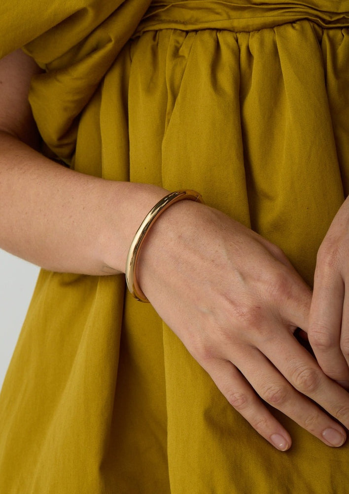 Gia high polished gold hinged bangle bracelet by Jenny Bird Manitoba Canada